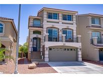 Inviting three-story home featuring a two-car garage and a charming second story balcony at 9784 Kodiak Island Ct, Las Vegas, NV 89141