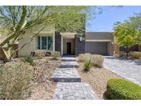 Charming single-story home with desert landscaping and a stone walkway leading to the front door at 10349 Bressana Dr, Las Vegas, NV 89135