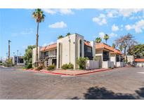 Inviting exterior view of condo complex, featuring a red tiled roof, mature landscaping, and private balconies at 1440 Vegas Valley Dr # 13, Las Vegas, NV 89169