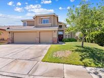 Charming two-story home featuring a spacious three-car garage and well-maintained front yard at 1870 Desert Forest Way, Henderson, NV 89012