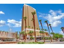Stunning exterior view of Trump International Hotel with palm trees and beautiful blue skies at 2000 N Fashion Show Dr # 2222, Las Vegas, NV 89109