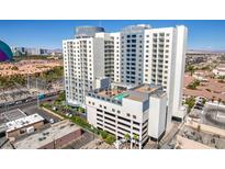Exterior view of the Platinum Hotel and Spa featuring a rooftop pool and surrounding buildings at 211 E Flamingo Rd # 402, Las Vegas, NV 89169