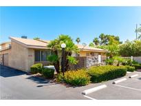Charming exterior view of the home featuring manicured landscaping and ample parking space at 2241 Tall Pine Dr, Las Vegas, NV 89108