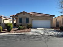 Charming single-story home featuring a well-maintained front yard and a two-car garage at 338 Brilliant Summit Cir, Henderson, NV 89052
