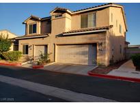 Charming stucco home featuring a two-car garage, manicured landscaping and a warm, inviting atmosphere at 37 Belle Soleil Ave, Las Vegas, NV 89123