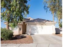 Charming single-story home with a well-maintained front yard and two-car garage at 4848 Cutting Diamond Ct, North Las Vegas, NV 89081