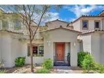 Charming home featuring xeriscape landscaping and a lovely orange front door at 530 Sonoma Range St, Las Vegas, NV 89138