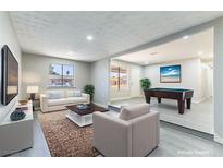 Comfortable living room with modern decor, featuring a billiard table and stylish furniture at 5800 Auborn Ave, Las Vegas, NV 89108