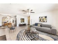 Bright living room boasts a ceiling fan, neutral paint, and an open floor plan for easy entertaining at 5809 Pebble Beach Blvd, Las Vegas, NV 89108