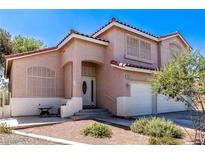Charming stucco home features a red tile roof, arched entry, and a two-car garage at 6293 Pavestone Ln, Las Vegas, NV 89142