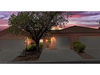 Charming single-Gathering home with attached garage, tile roof, desert landscaping, and a view of the vibrant sunset sky at 731 Appletree Ln, Mesquite, NV 89027