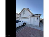 Charming two-story home with a white exterior, a two-car garage, and a beautifully paved driveway at 8064 Kentshire Dr, Las Vegas, NV 89117