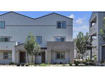 A charming townhome featuring a covered entryway, neutral stucco, and well-maintained landscaping at 8436 Noir Ave, Las Vegas, NV 89129