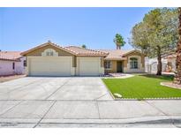 Charming single-story home with a well-manicured lawn, a two car garage, and a tile roof at 849 Ringwood Ln, Las Vegas, NV 89110