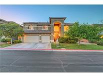 Attractive two-story home features a three-car garage and well-manicured front yard at 8812 Glenistar Gate Ave, Las Vegas, NV 89143