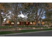 Charming single-story home featuring a well-manicured lawn, mature trees, and a two-car garage at 9 Quail Run Rd, Henderson, NV 89014
