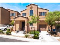 Charming two-story home with landscaped front yard and attached garage on a sunny day at 9112 Picturesque Ave, Las Vegas, NV 89149