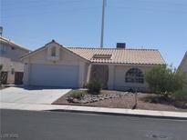 Charming single-story home features a desert landscape, and an attached two-car garage at 918 Ambusher St, Henderson, NV 89014