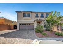 Attractive two-story home featuring a neutral color scheme and beautiful front yard landscaping at 10325 Quartz Reef Ct, Las Vegas, NV 89141