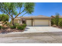 Charming single story home featuring a three-car garage and well-maintained landscaping in a suburban neighborhood at 2016 Biloxi Pass, Henderson, NV 89052