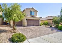 Charming two-story home featuring a two-car garage and a well-maintained front yard with mature tree at 210 Red Sandstone Ave, North Las Vegas, NV 89031