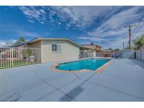 Backyard pool area with lounge chairs, light blue pool, and light blue painted concrete at 224 Catalini St, Las Vegas, NV 89107