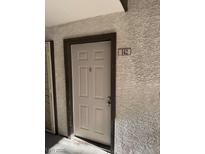 Beige front door with unit number 142 featured on the exterior of the building at 2606 S Durango Dr # 142, Las Vegas, NV 89117