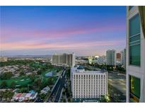 Expansive city view featuring a golf course and the iconic Las Vegas skyline at dusk at 322 Karen Ave # 2501, Las Vegas, NV 89109