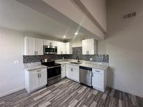 Modern kitchen features stainless steel appliances, granite countertops, and mosaic backsplash at 3681 Melonies Dr # 29, Las Vegas, NV 89103