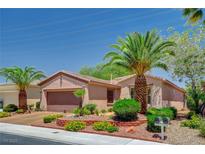 Single story stucco home with a two-car garage, professional landscaping and palm trees at 4174 Cascada Piazza Ln, Las Vegas, NV 89135