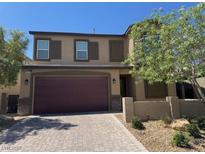 Attractive two-story home boasts a brick driveway, two-car garage, and well-maintained front yard at 4337 Stardusk Falls Ave, North Las Vegas, NV 89084