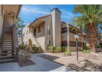 Charming condo exterior with landscaped grounds, stucco facade, and a beautiful palm tree at 4742 Obannon Dr # A, Las Vegas, NV 89102