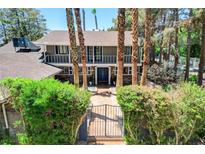 Inviting two-story home with mature landscaping, gated entry, and charming curb appeal at 5260 N Jones Blvd, Las Vegas, NV 89130