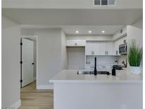 Modern kitchen featuring white cabinets, quartz countertops, and a stainless steel microwave at 555 E Silverado Ranch Blvd # 2129, Las Vegas, NV 89183