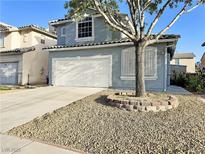 Charming two-story home with a well-maintained front yard and a two-car garage at 6063 Peach Orchard Rd, Las Vegas, NV 89142
