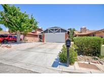 Charming single-story home featuring a two-car garage, desert landscaping, and a mature shade tree at 6924 Senton Ave, Las Vegas, NV 89108