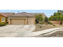 Charming single-story home featuring a desert landscape and a spacious two-car garage at 7559 Chambery Cove Ct, Las Vegas, NV 89123
