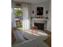 Bright living room with fireplace, modern decor, and sliding doors to outdoor balcony at 7885 W Flamingo Rd # 2129, Las Vegas, NV 89147