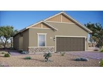 Charming single-story home with a two-car garage and desert landscaping offers an inviting curb appeal at 86 Sonata Dawn Ave, Henderson, NV 89011