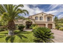 Elegant two-story home featuring desert landscaping, tile roof, and a three-car garage at 11241 Pentland Downs St, Las Vegas, NV 89141