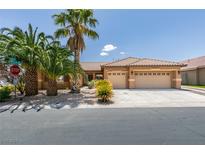 Charming single-story home with a three-car garage, mature landscaping, and desert landscaping at 1453 Doggett Ave, Las Vegas, NV 89123