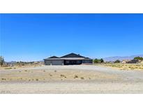 Charming single-story home with desert landscaping, mountain views and spacious, oversized lot at 1830 Justine Ct, Pahrump, NV 89048