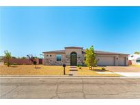 Charming single-story home with a well-maintained front yard and a three-car garage at 211 E Kimberly Dr, Henderson, NV 89015