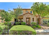 Charming two-story home featuring a stone facade, well-maintained landscaping, and inviting front porch at 2370 Via Firenze, Henderson, NV 89044