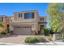 Inviting two-story home featuring a two-car garage and well-maintained front yard with shrubs at 2856 Trossachs St, Henderson, NV 89044