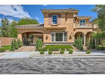 Stunning two-story home featuring an attached garage, landscaped front yard, and charming architectural details at 3198 Stella Cilento Ave, Henderson, NV 89044