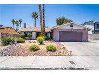 Charming single-story home featuring a two-car garage, mature landscaping, and desert-friendly rock accents at 4129 Ridgewood Ave, Las Vegas, NV 89120