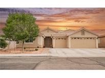 Charming single-story home boasts a tile roof, desert landscaping, and a spacious three-car garage at 47 Desert Sunflower Cir, Henderson, NV 89002