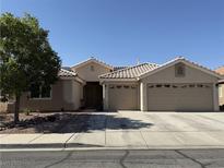 Charming single-story home featuring a tile roof and a spacious two-car garage at 47 Desert Sunflower Cir, Henderson, NV 89002