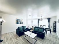 Bright and airy living room with wood floors and modern furnishings at 5821 Marka Dr, Las Vegas, NV 89108